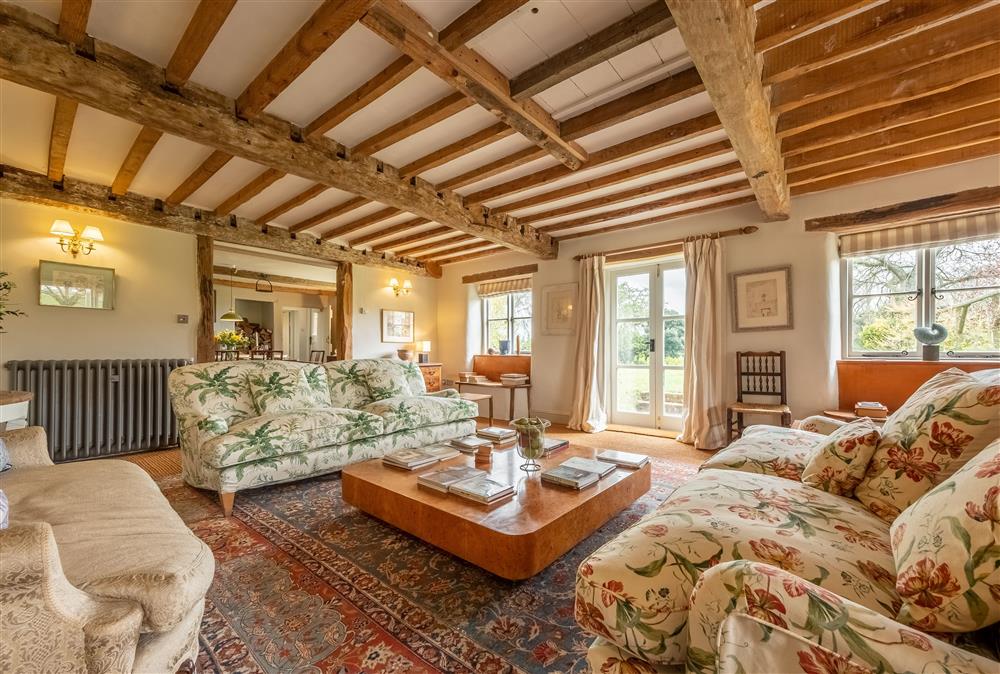Cosy sitting room with comfortable seating for all guests and exposed beams throughout the room