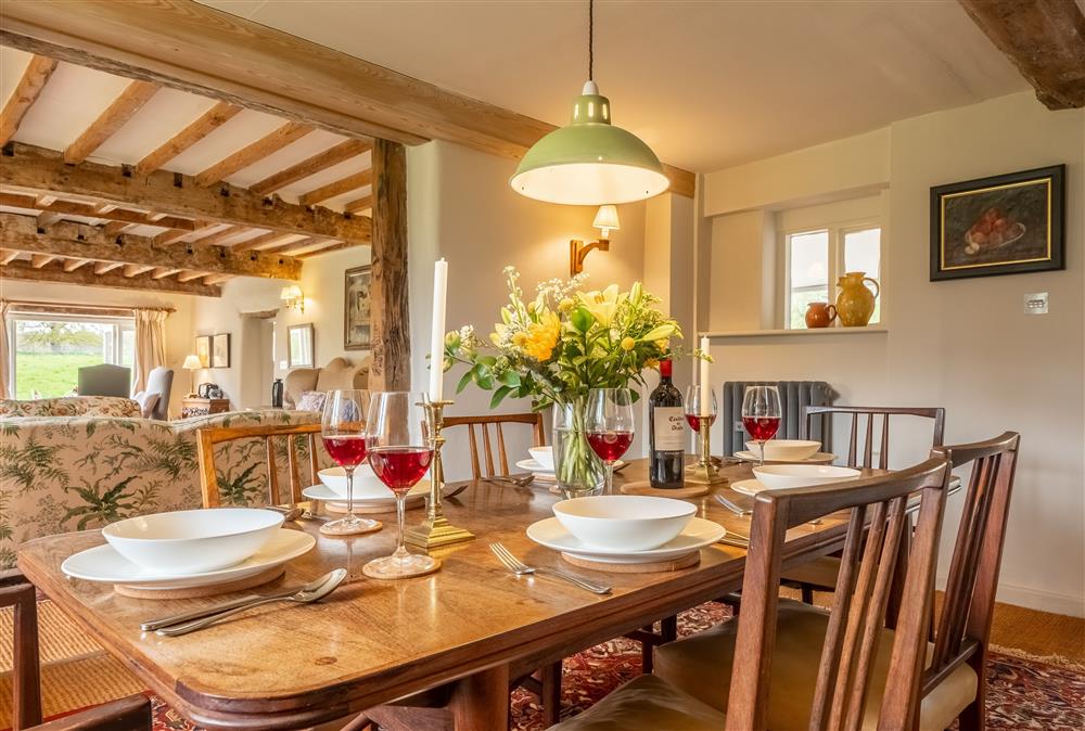 The dining room leads into the kitchen and sitting room at Keepers Cottage, Wolterton
