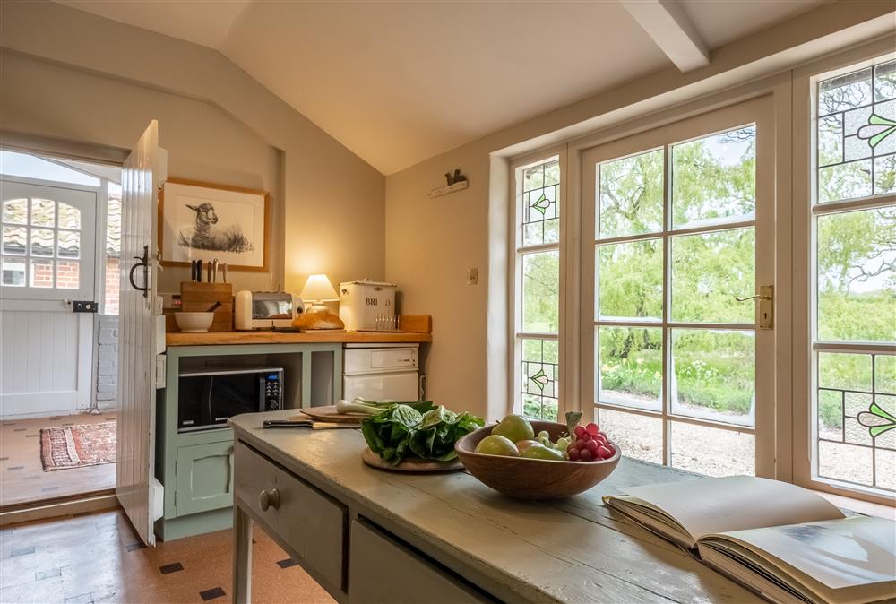 The kitchen looking out to the garden and surrounding parkland at Keepers Cottage, Wolterton