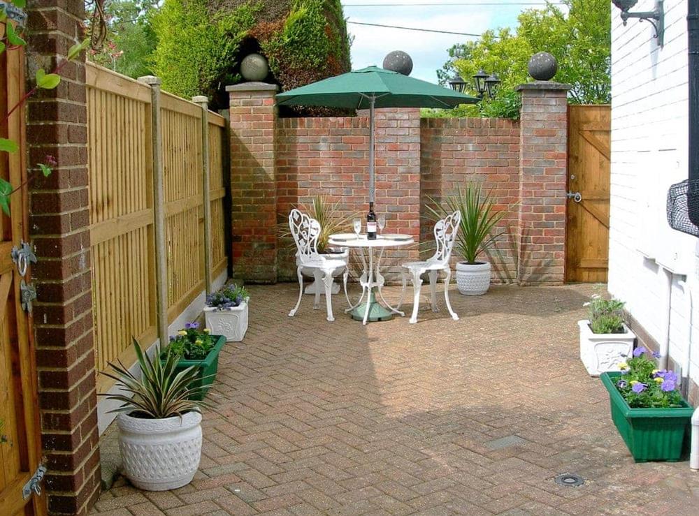 Patio area with sitting out furniture at Keith Cottage in Sway, near Lymington, Hampshire