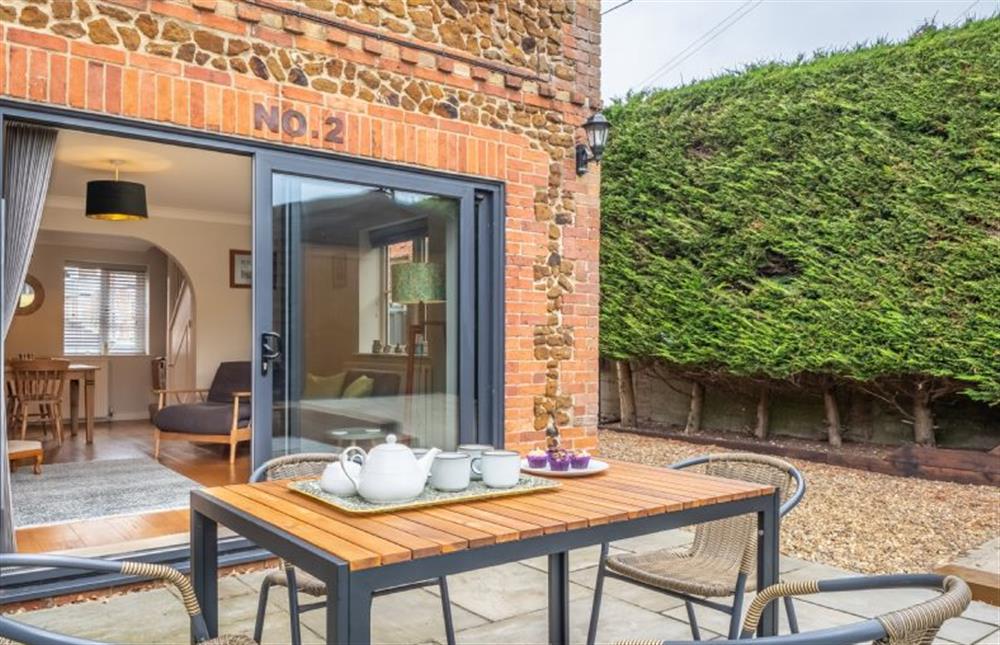 Outside there’s a peaceful patio area with garden furniture at Ken Hill Cottage, Snettisham near Kings Lynn
