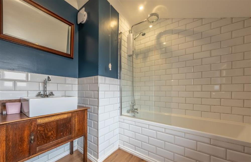 The bathroom has bath with shower over at Ken Hill Cottage, Snettisham near Kings Lynn