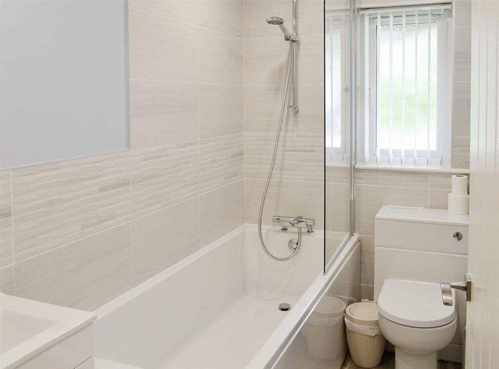 Family bathroom with shower over bath at Bluebell, 