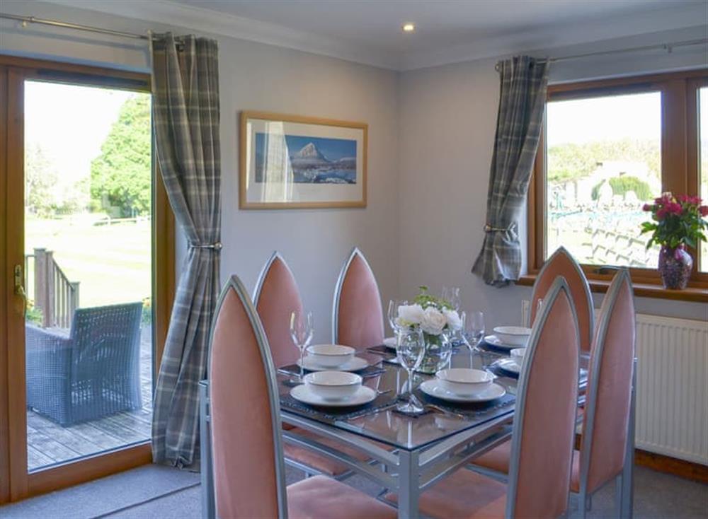 Beautiful formal dining area with doors to the decked area at Kilmore House in Drumnadrochit, near Inverness, Inverness-Shire