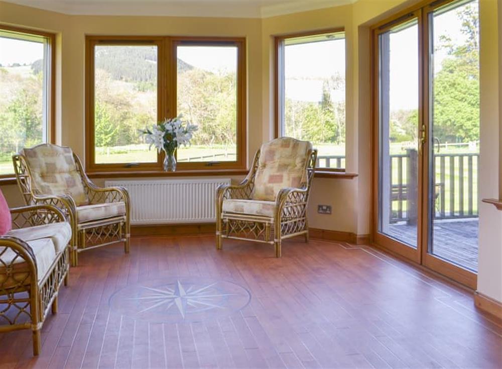 Sunny tile-floored conservatory with sliding doors