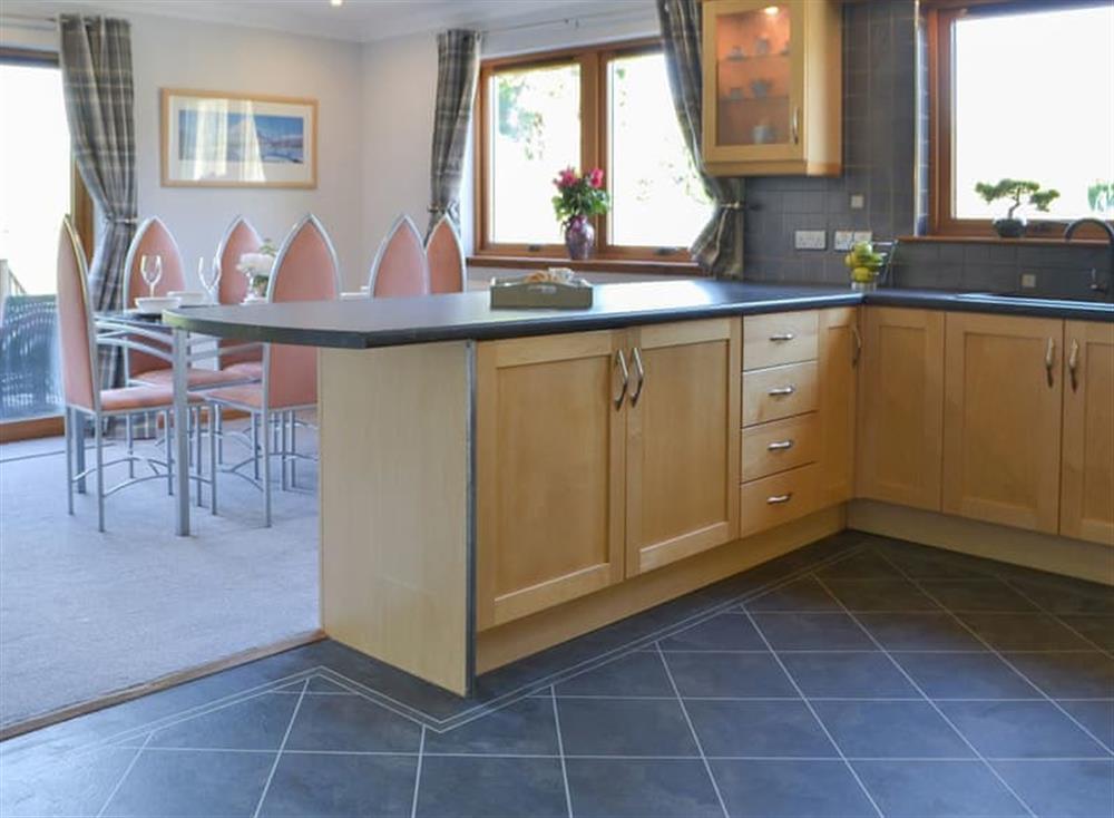Tile-floored kitchen giving onto the dining area at Kilmore House in Drumnadrochit, near Inverness, Inverness-Shire