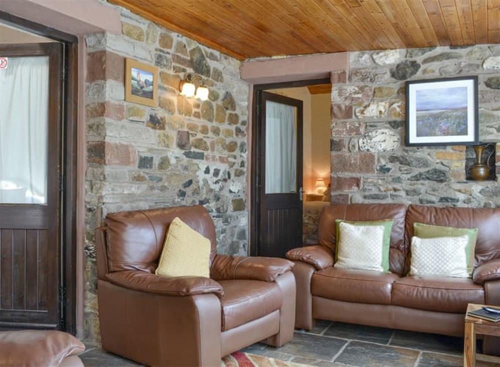 Comfy seating within living room at Skiddaw Cottage, 