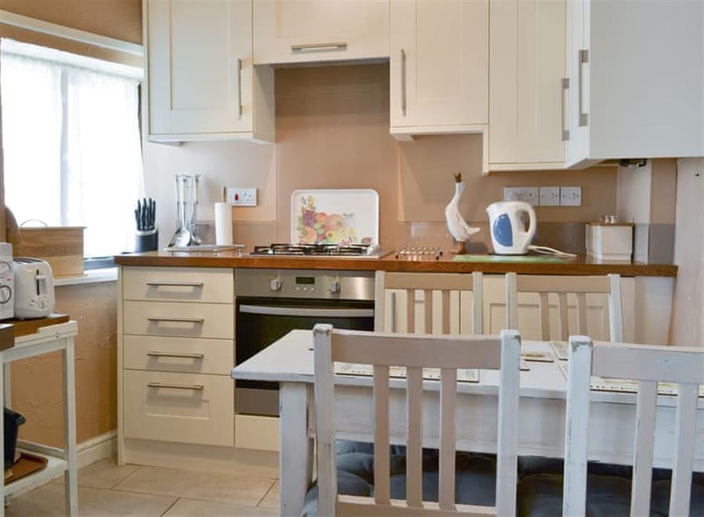 Fully appointed kitchen with dining area at Skiddaw Cottage, 