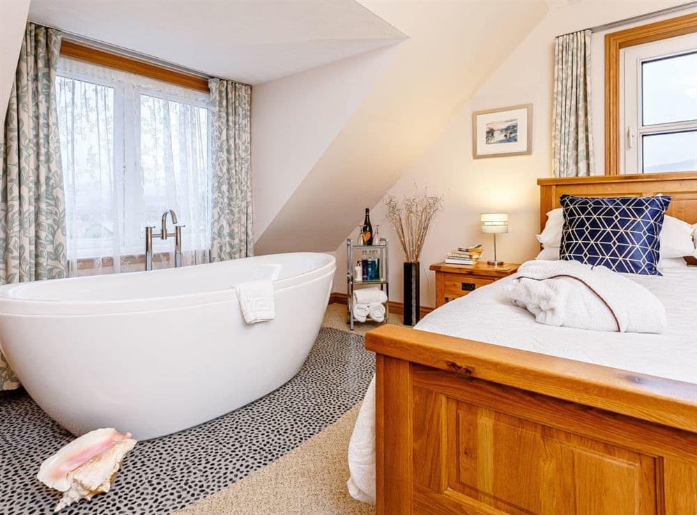 Double bedroom with open bathing area at Holly View Annexe, 