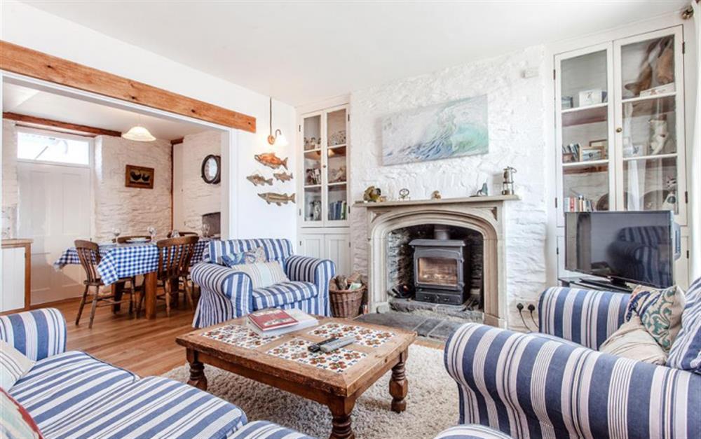 The delightful sitting room with woodburner stove. at Kimberley Cottage in Beesands
