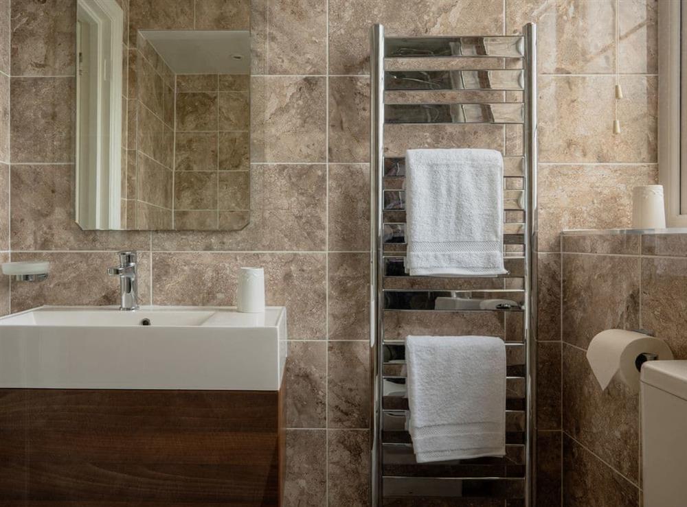 Modern shower room with heated towel rail at Kinbrae Apartment in Torquay, Devon