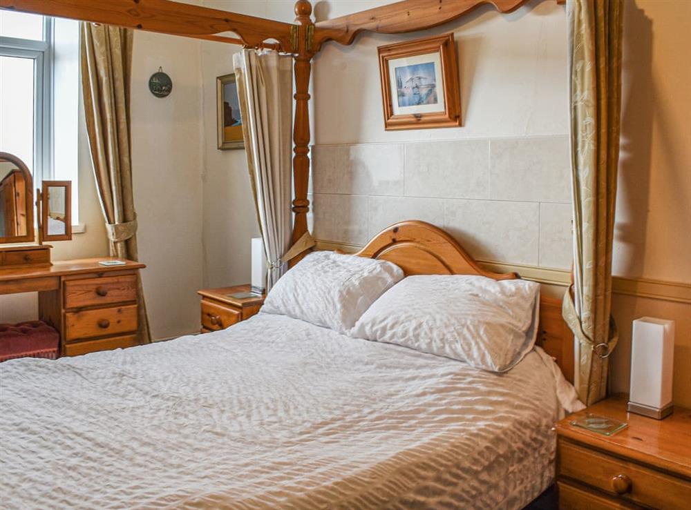 Four Poster bedroom at King Arthur Suite in Trearddur Bay, Anglesey, Gwynedd
