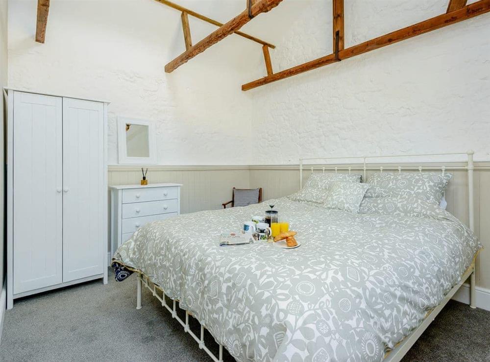 Romantic double bedroom with super kingsize bed at The Stables, 