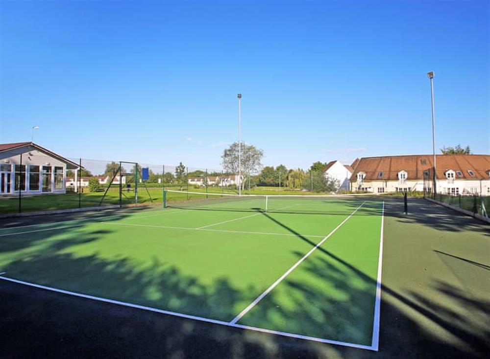Tennis court at Kingfisher Lake House in Cotswold Lakes, Gloucestershire