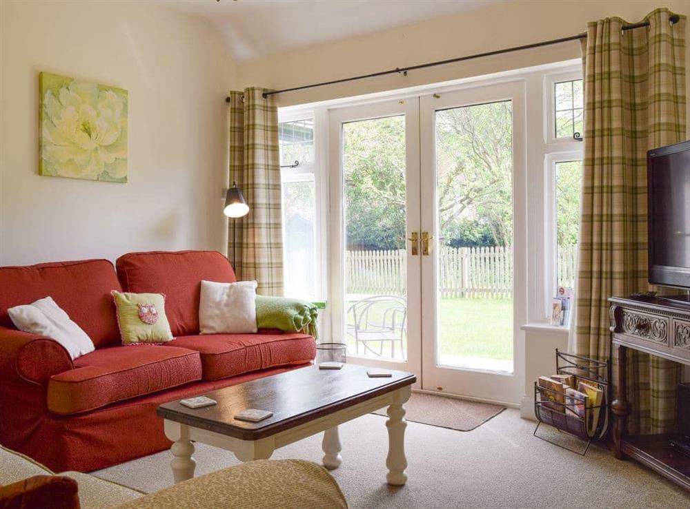 Living room with French doors to garden at Kingshill Farm Cottage in Little Kingshull, near Great Missenden, Buckinghamshire