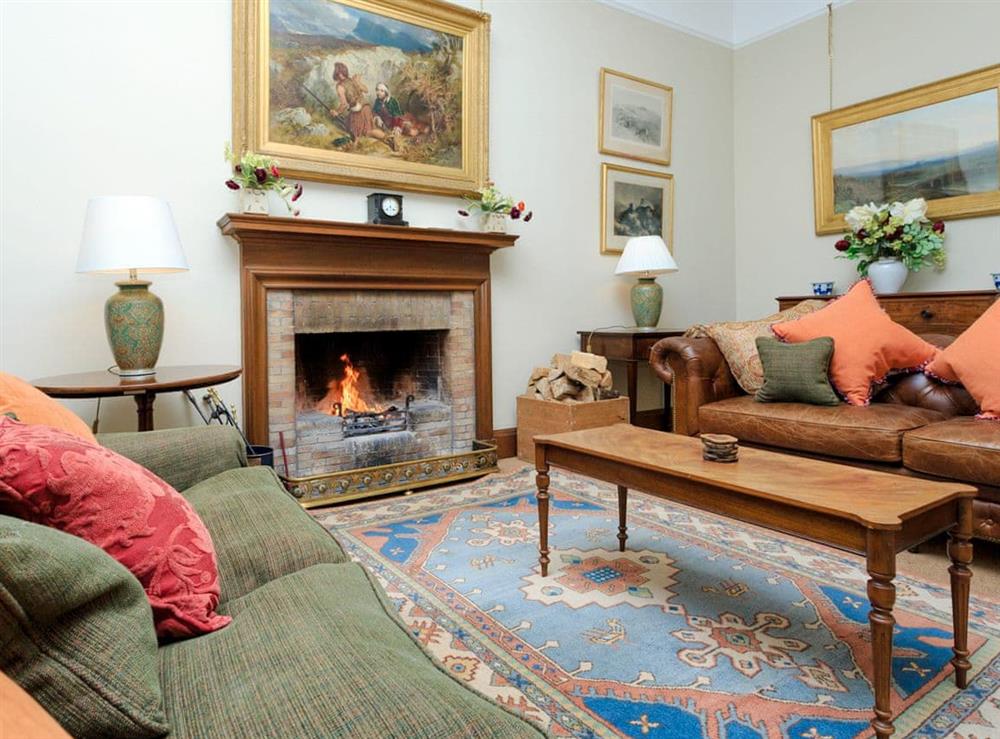 Comfortable living room with a cosy open fire at Macduff Tower, 