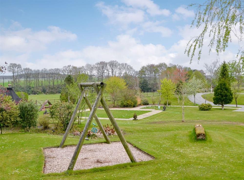 Extensive gardens and swing at Kinnelhook Holiday Cottage in Lochmaben, near Lockerbie, Dumfriesshire