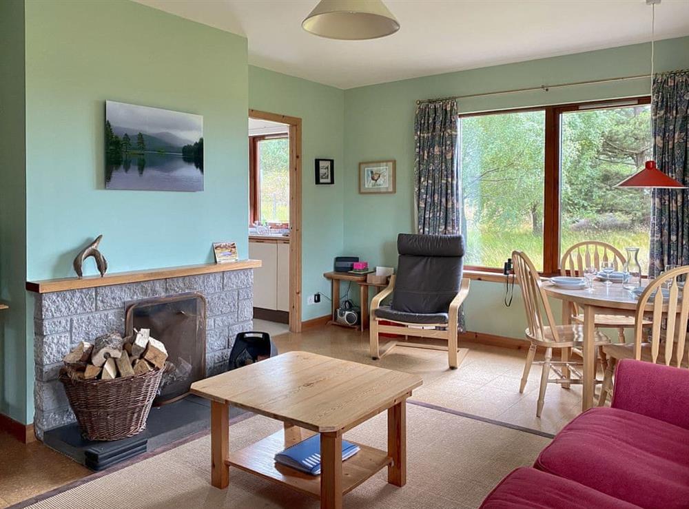Living room with dining area at Kintulloch in Inveruglas, near Kingussie, Inverness-Shire
