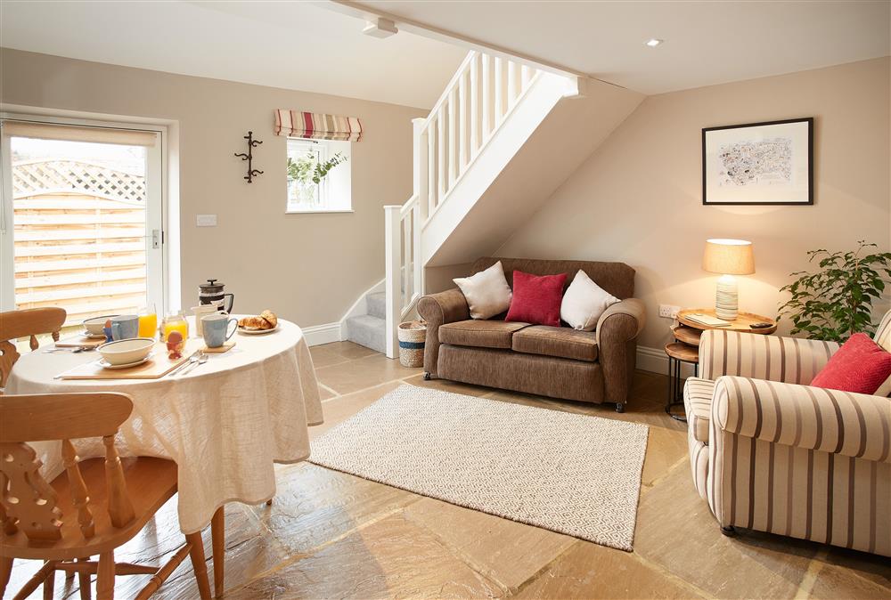 Enjoy a relaxing meal in the open plan dining area and sitting room at Kirby Cottage, Harome
