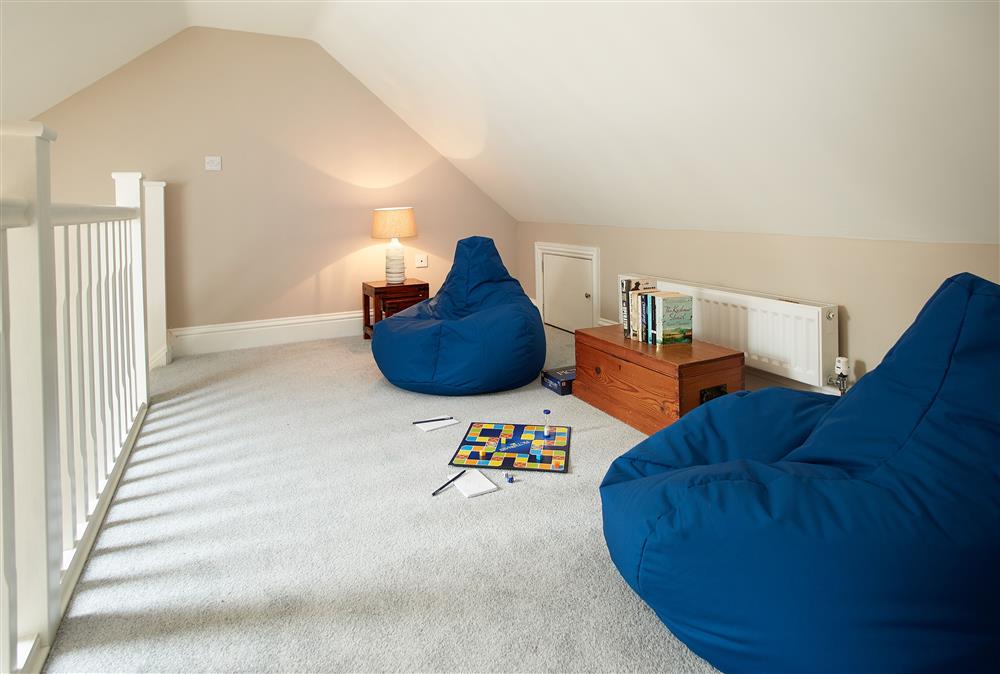 Gallery seating area - the perfect spot to relax reading a book at Kirby Cottage, Harome