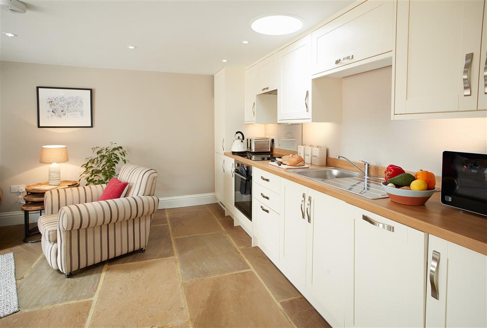 Kitchen with open plan dining area and sitting room at Kirby Cottage, Harome