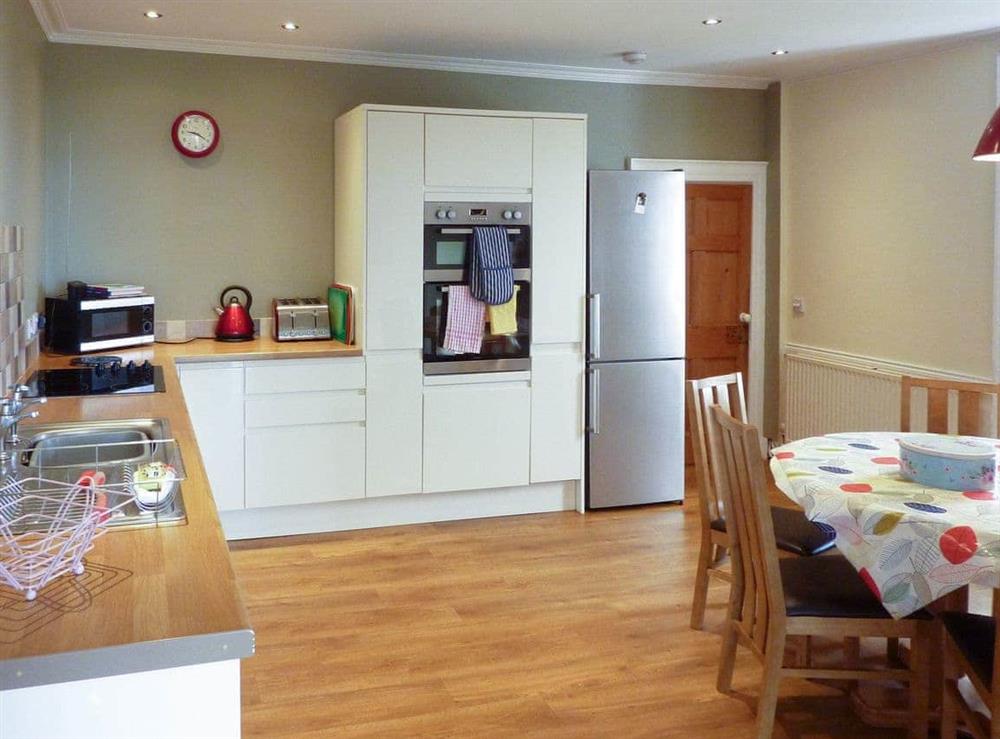 Fully appointed kitchen with dining area at Kirkbride Farmhouse in Carsluith, near Newton Stewart, Wigtownshire