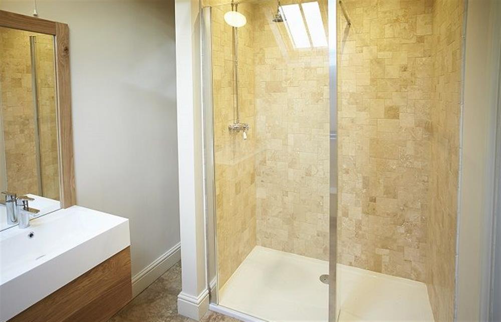 En-suite to master bedroom with a natural limestone tiled walk in shower at Kirkbride Hall, Melmerby