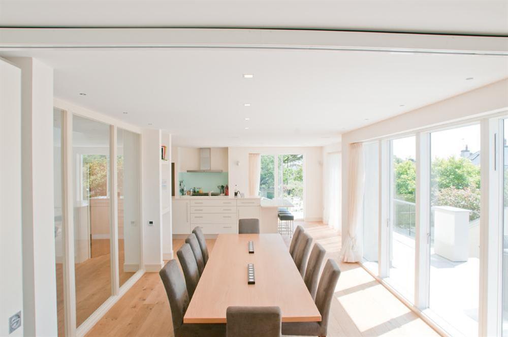 Large formal dining area adjacent to the kitchen with sliding glass doors to front terrace at Kirkdale in Thurlestone, Nr Kingsbridge