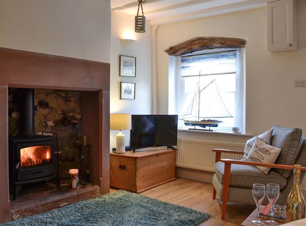 Cosy living room with wood burner at Kirkeway in Allonby, near Maryport, Cumbria