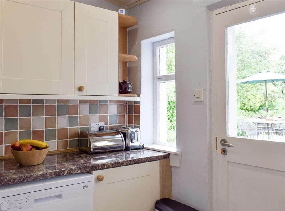 Well-equipped kitchen with access to patio area at Kirkview Cottage in Upper Largo, near Leven, Fife