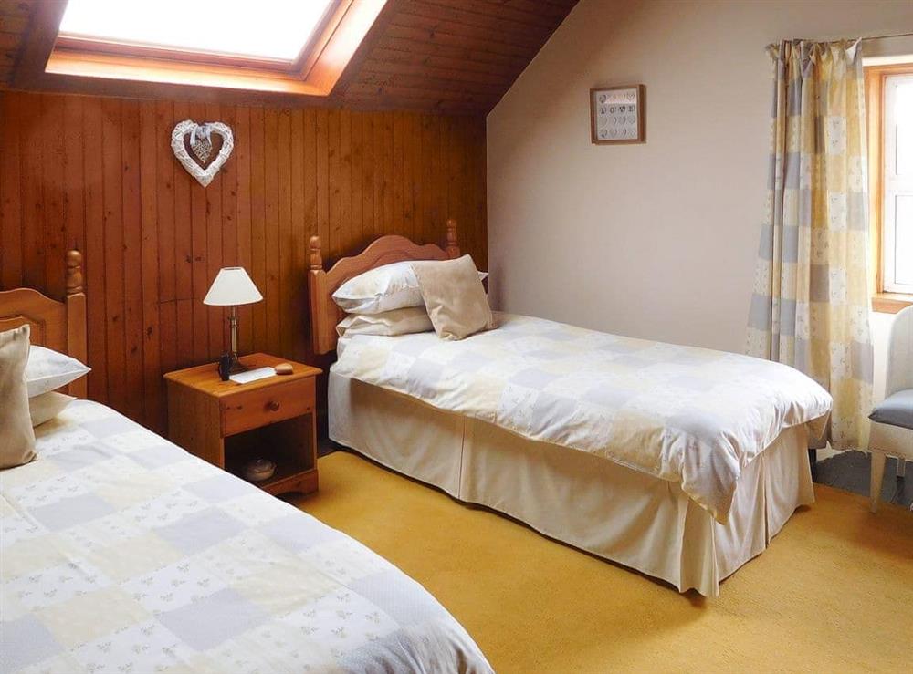 Spacious twin bedroom with original wood lined walls at Kirnan Cottage in Kilmichael Glassary, near Lochgilphead, Argyll