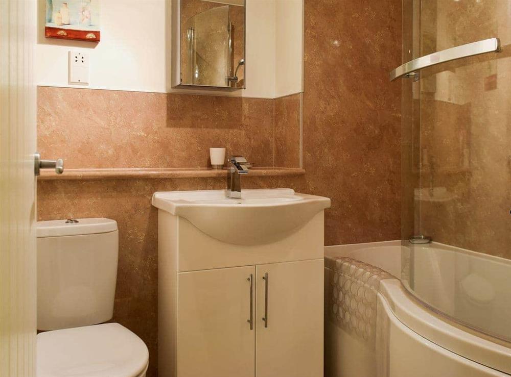 Family bathroom with shower over bath at Hewetson Court, 