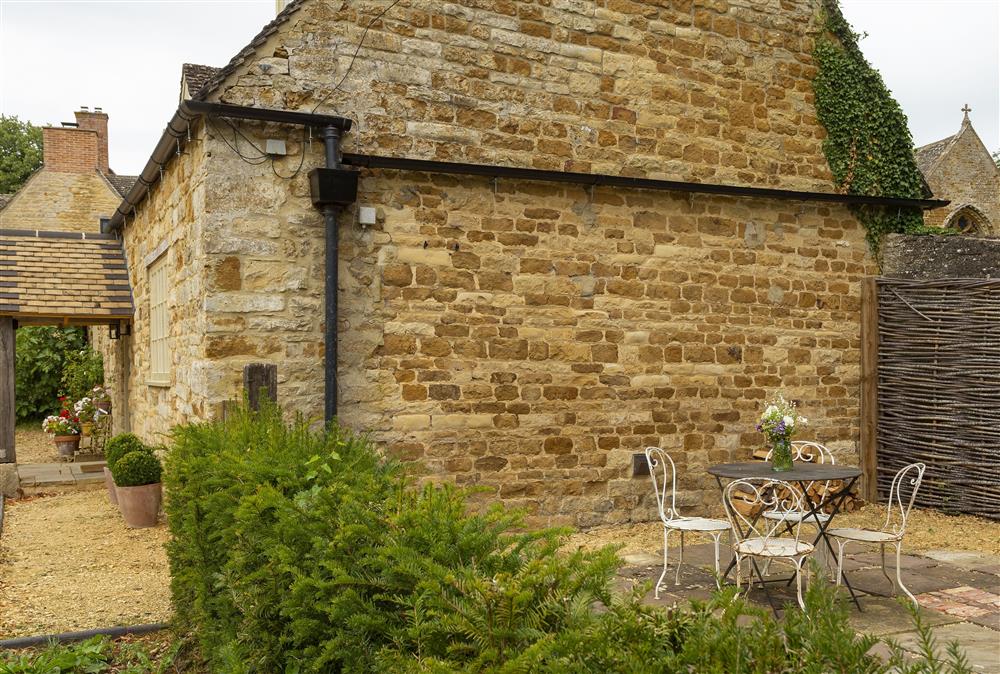 Pretty patio to the side of the cottage with views across the stunning countryside at Kitchen Garden Cottage, Barton-on-the-Heath