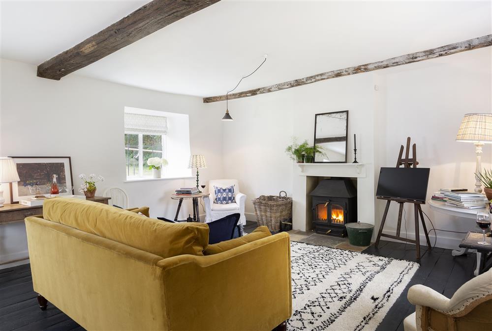 Spacious sitting room with wood burning stove at Kitchen Garden Cottage, Barton-on-the-Heath