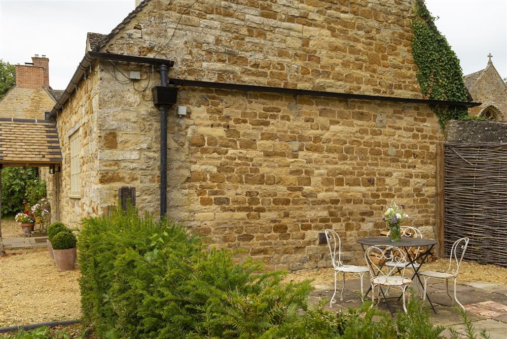 Pretty patio to the side of the cottage with views across the stunning countryside at Kitchen Garden Cottage, Moreton-in-Marsh