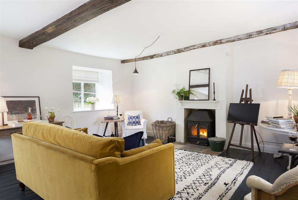 Spacious sitting room with wood burning stove at Kitchen Garden Cottage, Moreton-in-Marsh