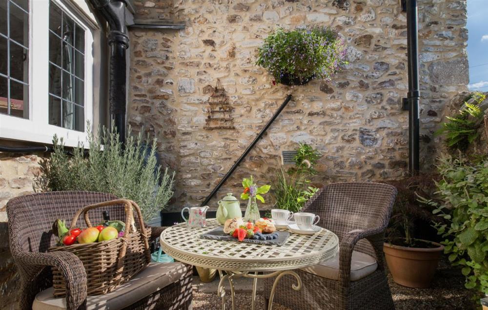 Seating and table for two with views of the village church and countryside at Kites Holt, Stockland