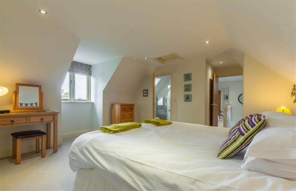 First floor: Bedroom two has an en-suite shower room at Kittiwake Cottage, Brancaster near Kings Lynn