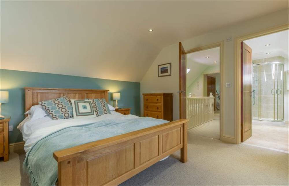 First floor: Master bedroom at Kittiwake Cottage, Brancaster near Kings Lynn