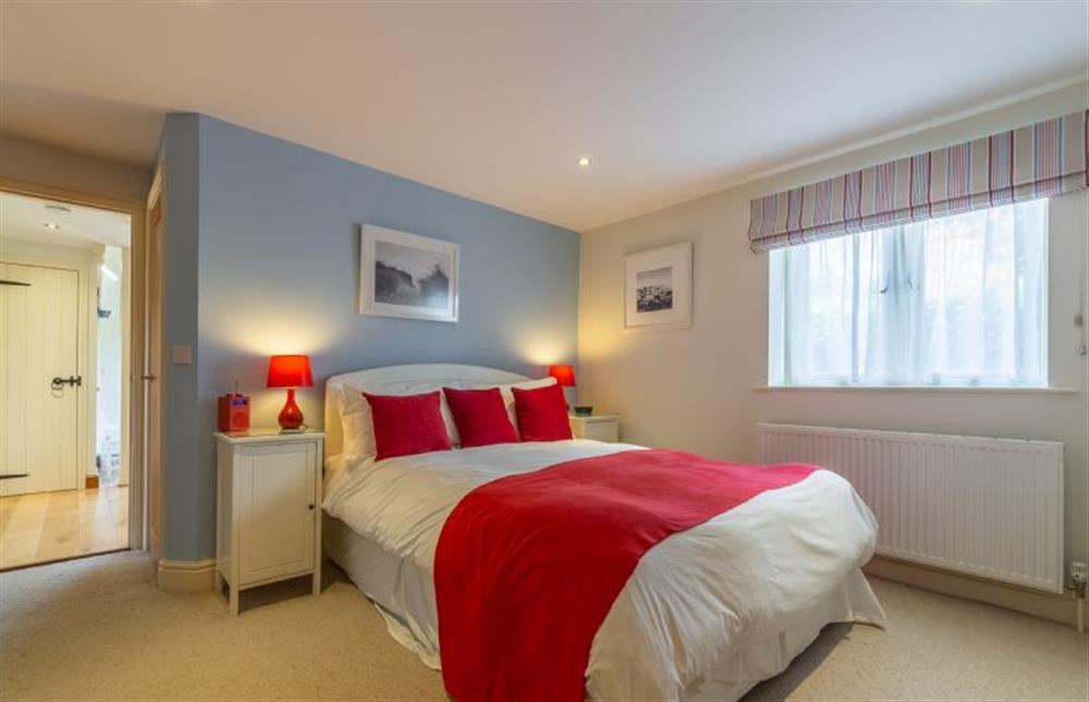 Ground floor: Bedroom three has a king-size bed at Kittiwake Cottage, Brancaster near Kings Lynn