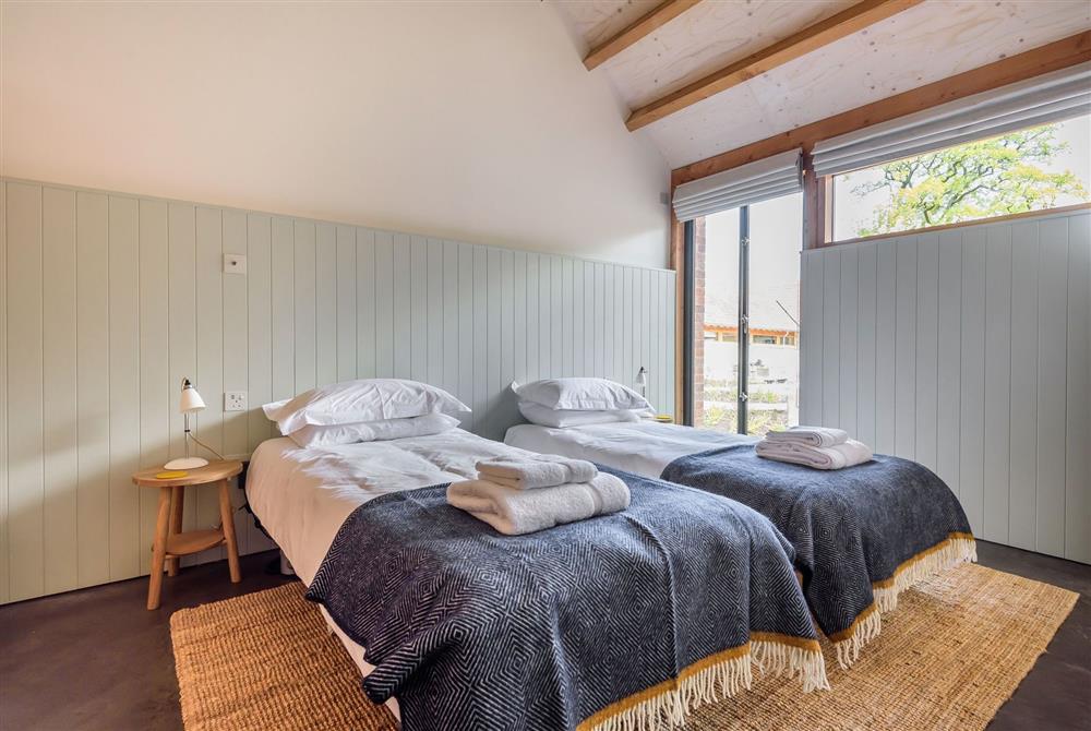 Bedroom two with twin profiling beds and exposed beams at Kittwhistle, Dorchester