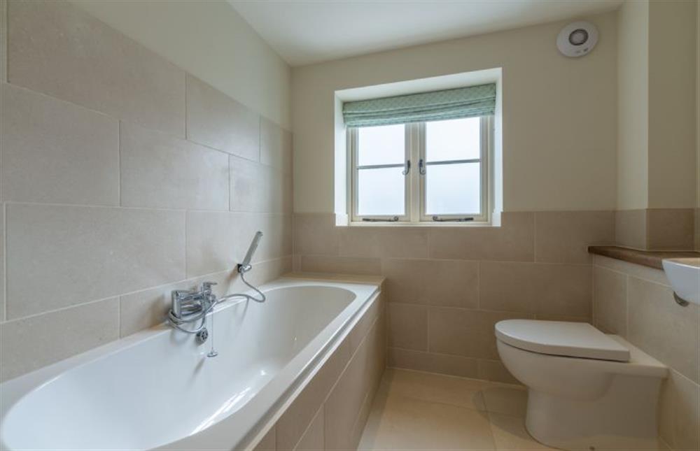 First floor: Family bathroom with double ended bath and hand-held shower at Kitty Coot, Burnham Overy Staithe near Kings Lynn