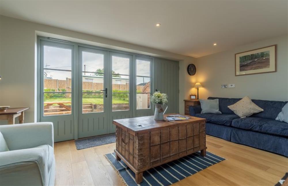 Ground floor: The sitting room has french doors to the garden at Kitty Coot, Burnham Overy Staithe near Kings Lynn