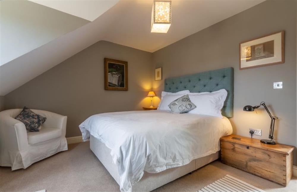 Second floor: The master bedroom has a king-size bed at Kitty Coot, Burnham Overy Staithe near Kings Lynn