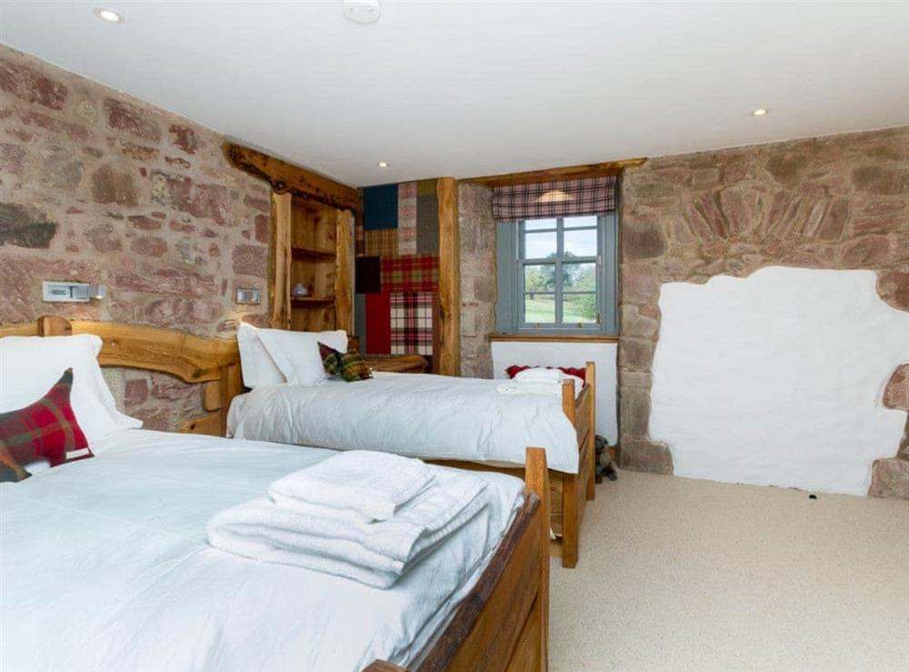 Twin bedroom with bare stone feature walls at Knock Old Castle in Largs, Ayrshire