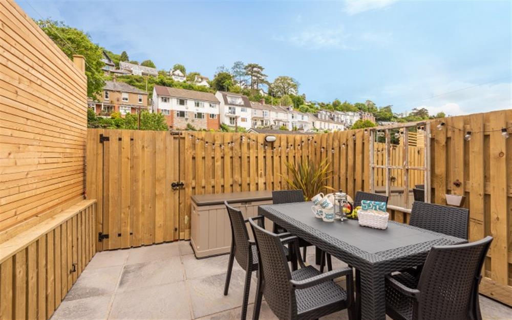 Enjoy alfresco dining on the peaceful rear patio. at Knott Cottage in Dartmouth