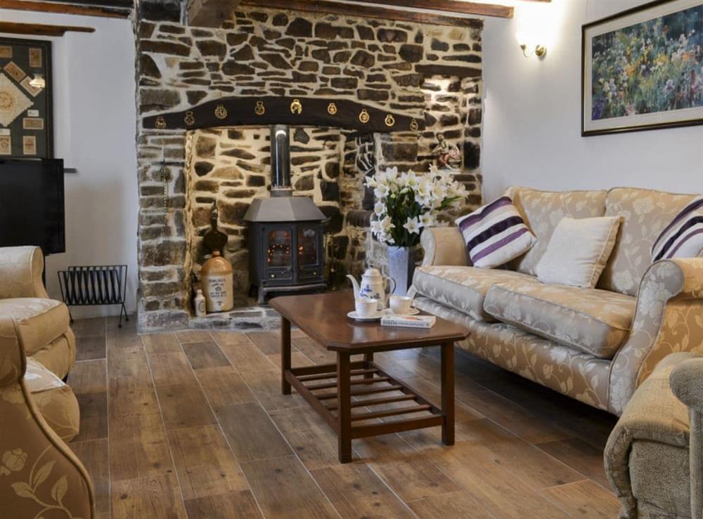 Comfortable living room with beams (photo 2) at Knotty Corner Cottage in Fairy Cross, near Bideford, Devon