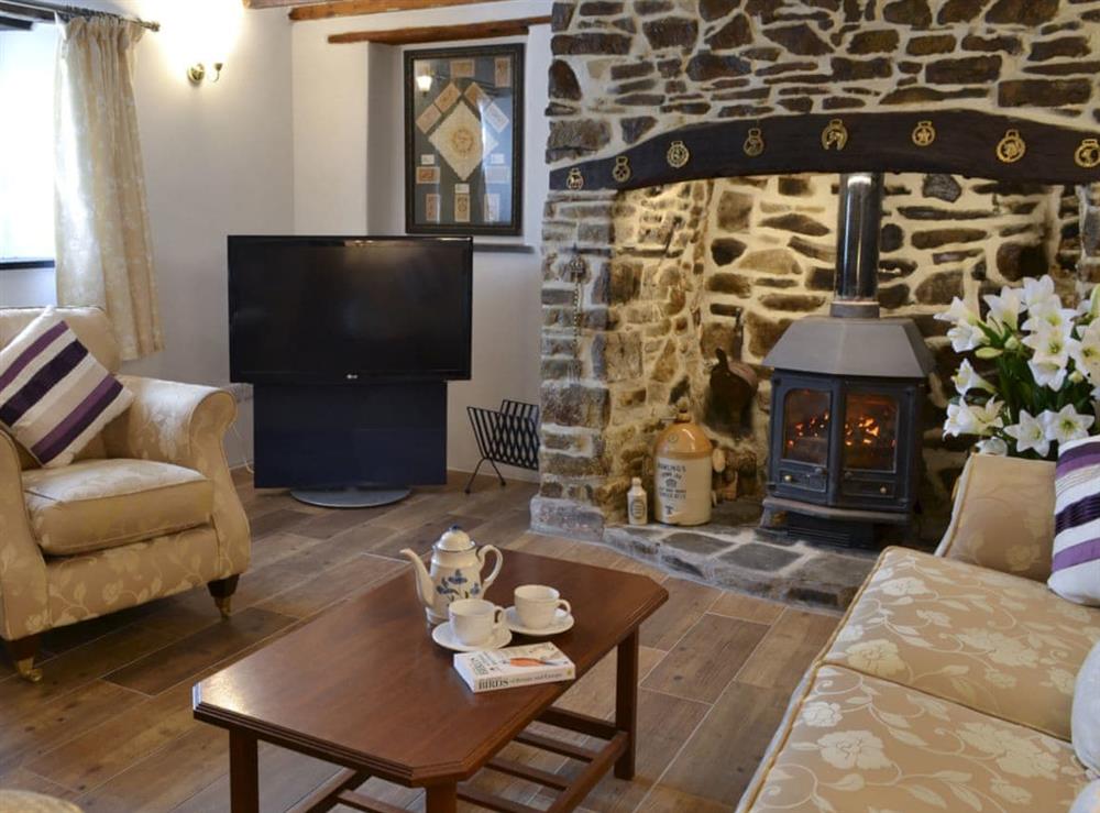 Comfortable living room with beams at Knotty Corner Cottage in Fairy Cross, near Bideford, Devon