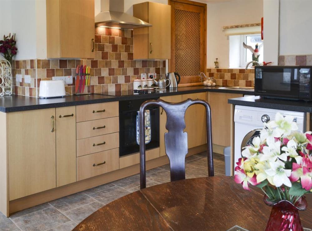 Kitchen with breakfast area at Knotty Corner Cottage in Fairy Cross, near Bideford, Devon