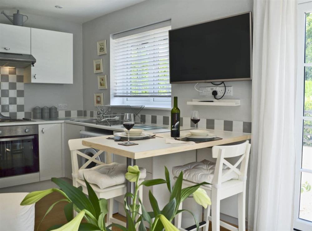 Tastefully modernised kitchen area with breakfast bar at Petit Knowle, 